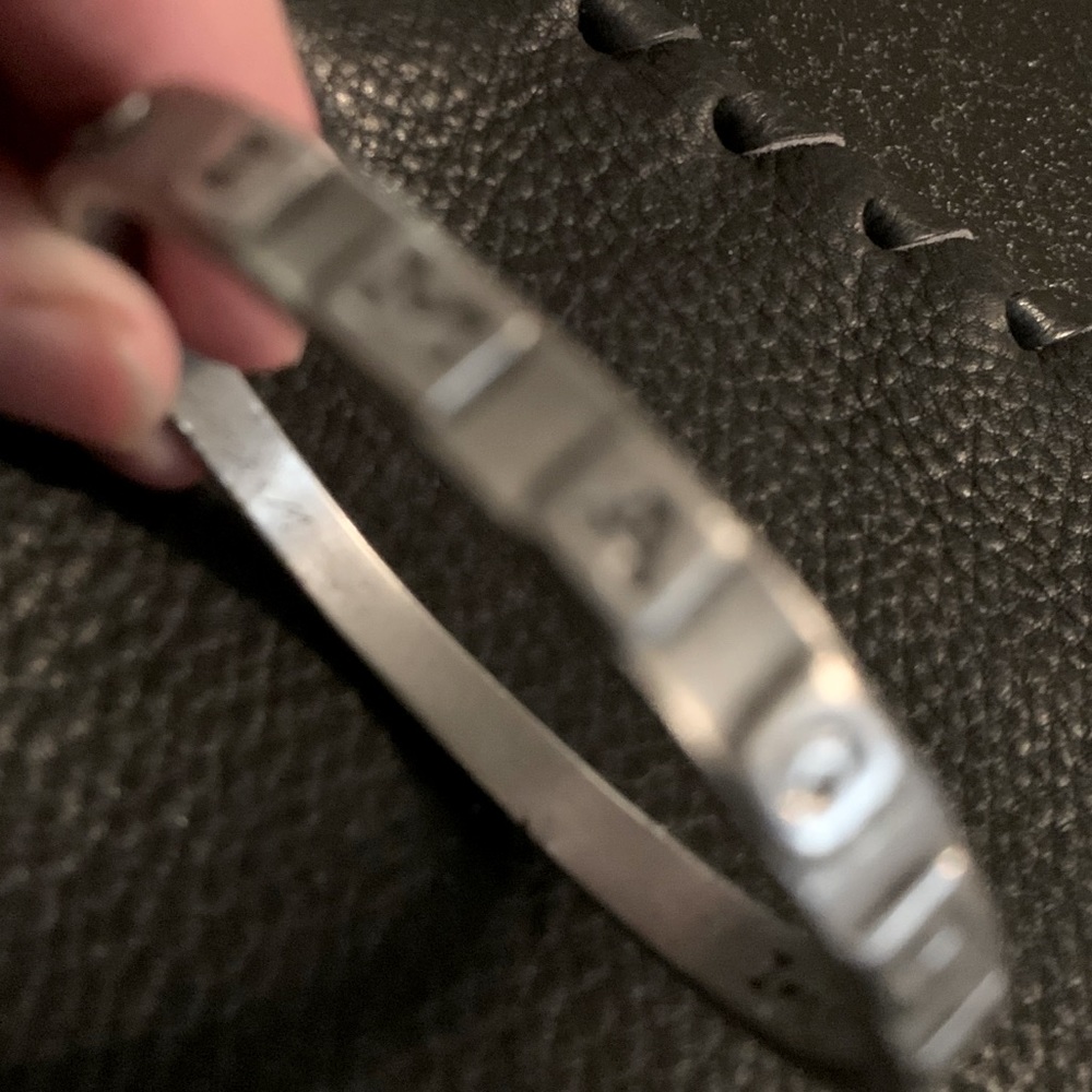Bracket. Pewter. Imagine is written on outside if bracelet.